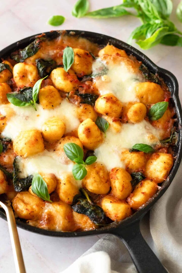 close up of a skillet pan with baked gnocchi