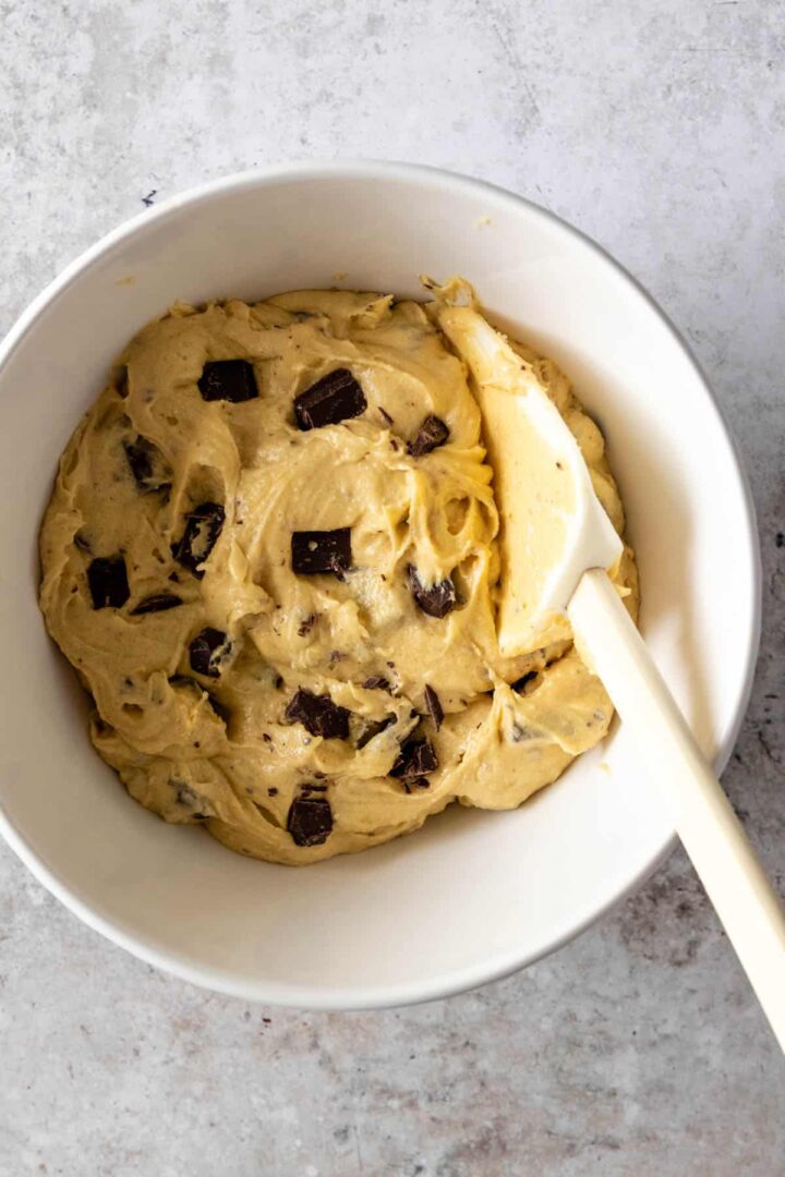 chocolate chip cookie dough inside a bowl with a spatula