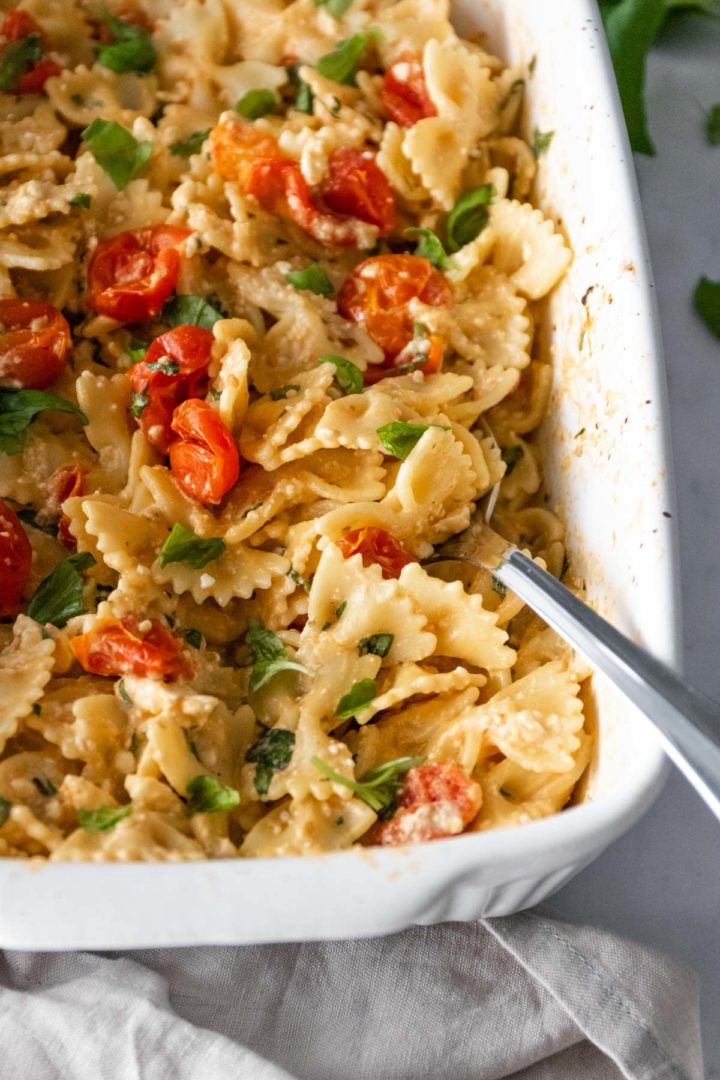 close-up of pasta with tomatoes, feta and chopped basil