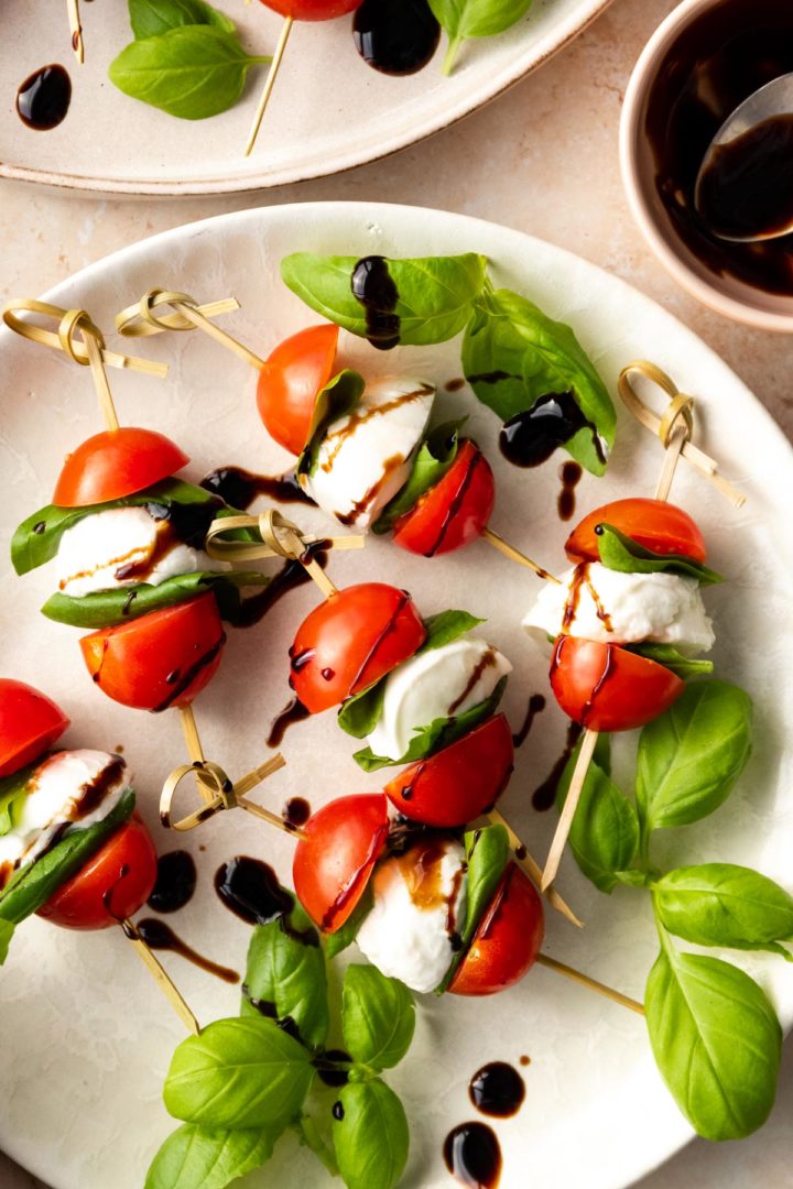 close up of a plate with caprese skewers