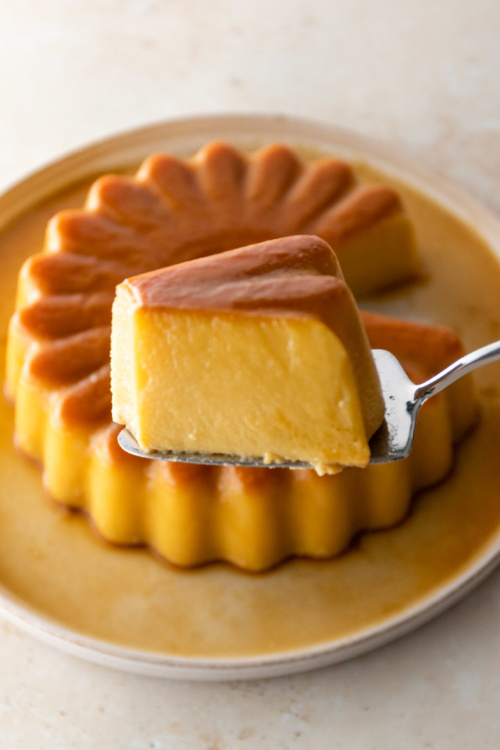 close up of a slice of coconut flan