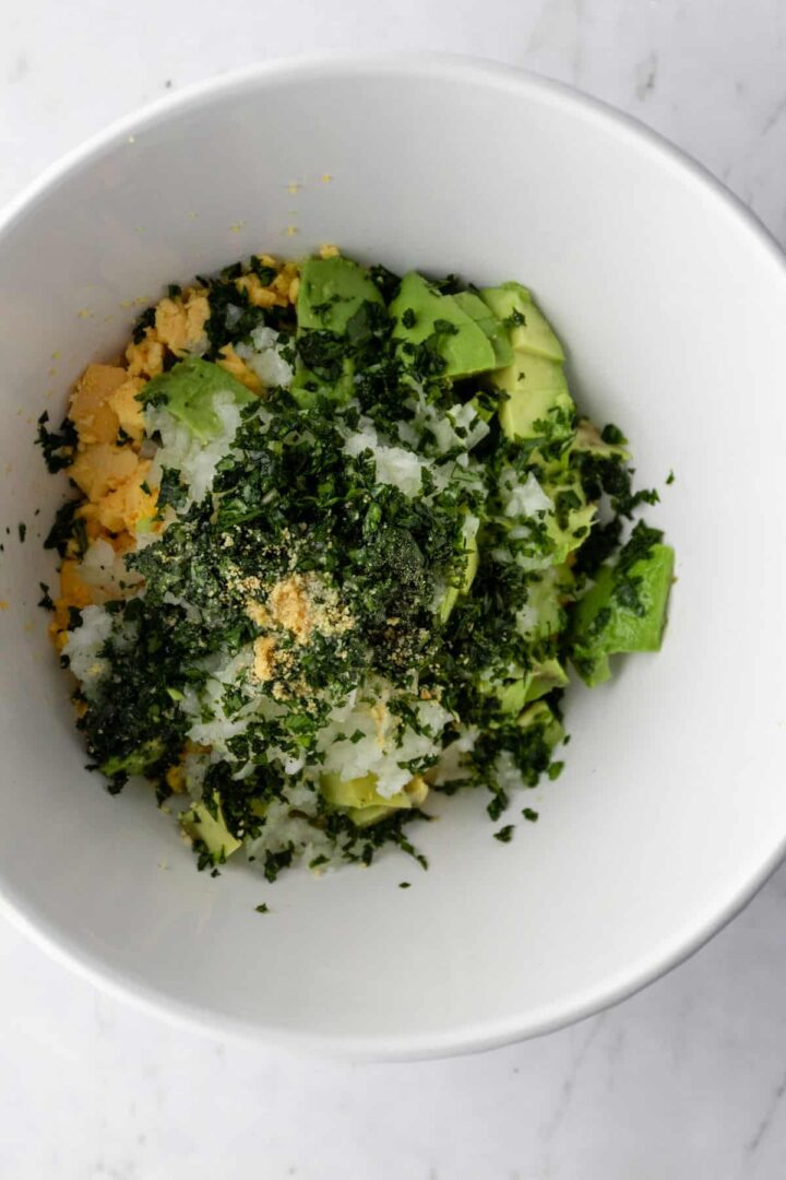 ingredients to make avocado deviled eggs filling on a bowl