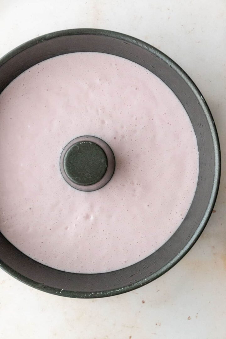 strawberry pudding mixture on a cake pan before going to the fridge