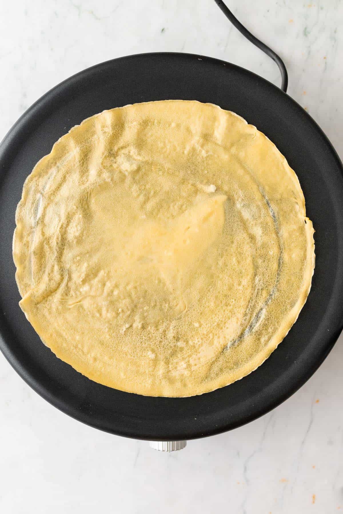 a crepe maker with one crepe on top